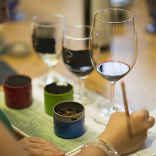 Woman taking notes while participating in the Aromatherapy Interactive Wine Experience at St. Supéry